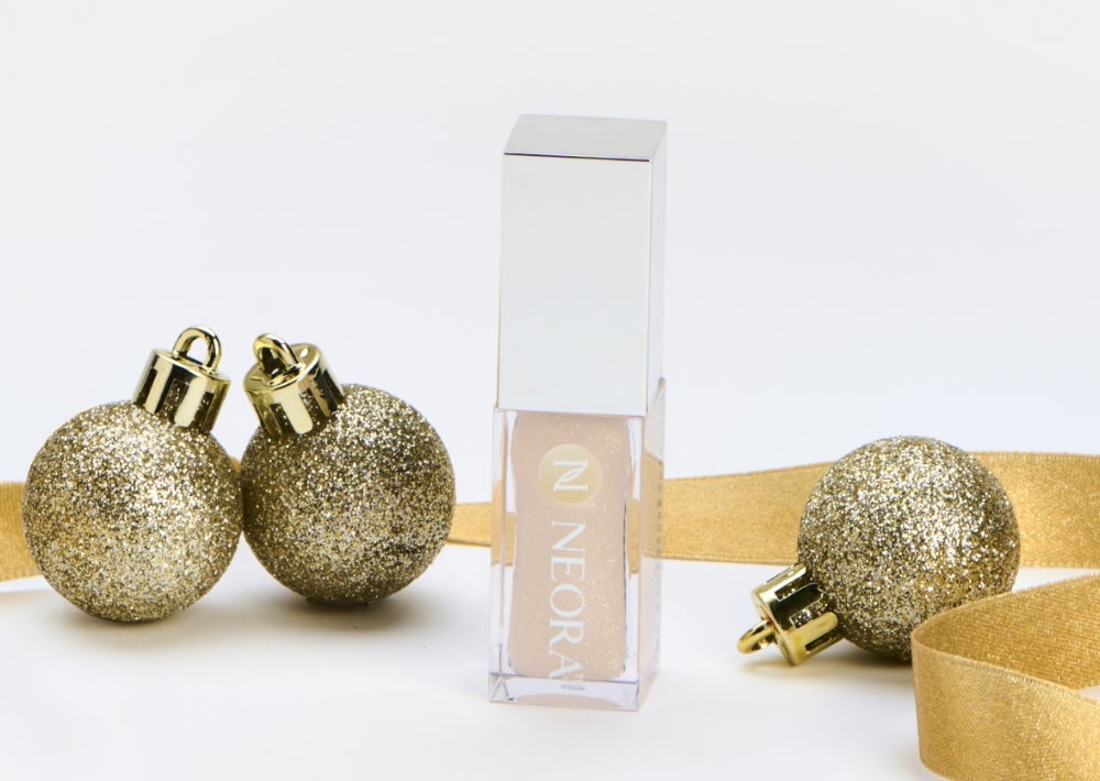 New limited-edition Shimmer Lip Oil. Achieve softly-shimmer, glamorously glossy and intensely hydrated lips for $40 retail or $33 with SmartShop. Background imagery includes a Shimmer Lip Oil container surrounded by gold ribbon and ornaments.