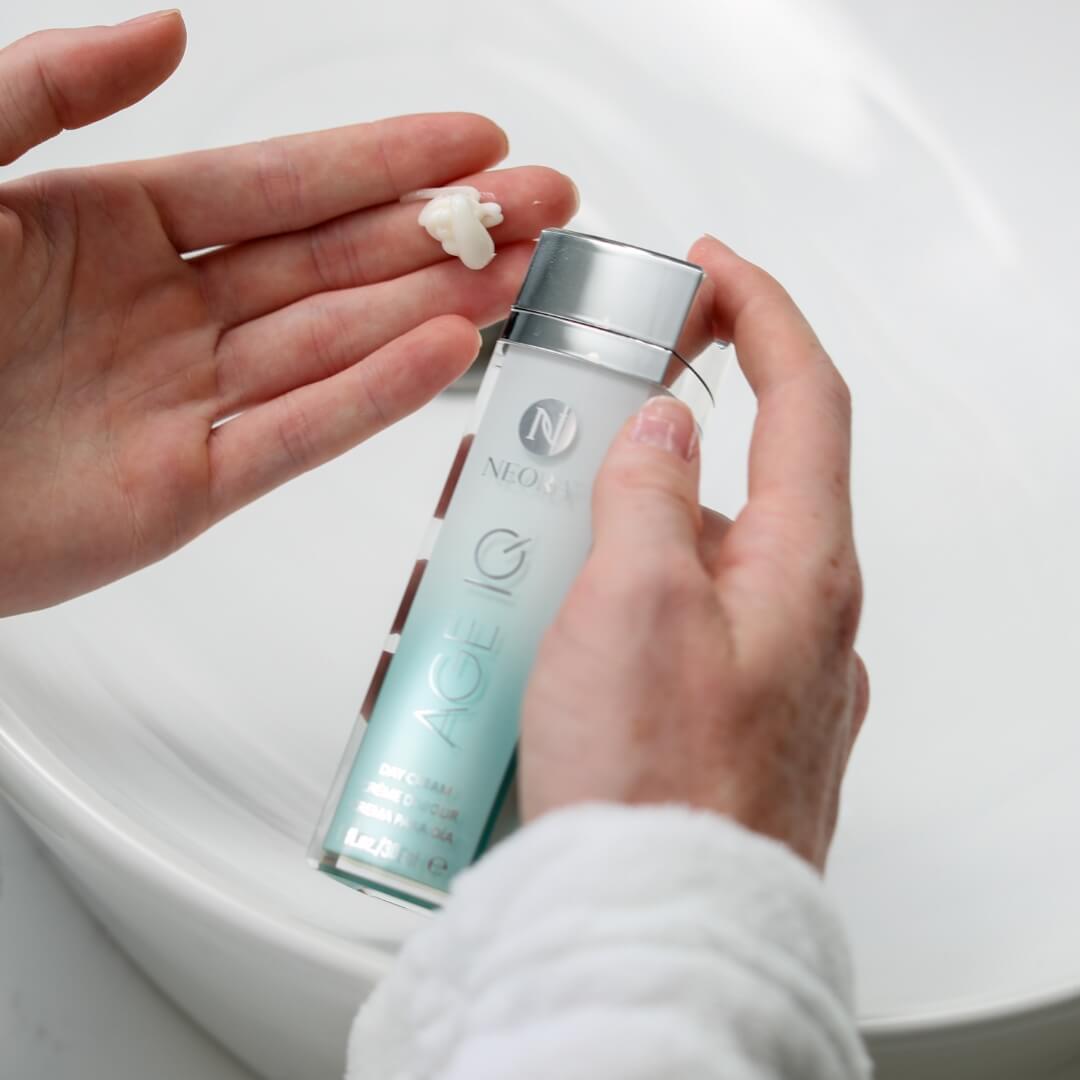 A woman using Neora's Day Cream on their hand.