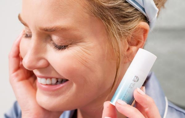 Image of woman applying Neora Eye Serum.