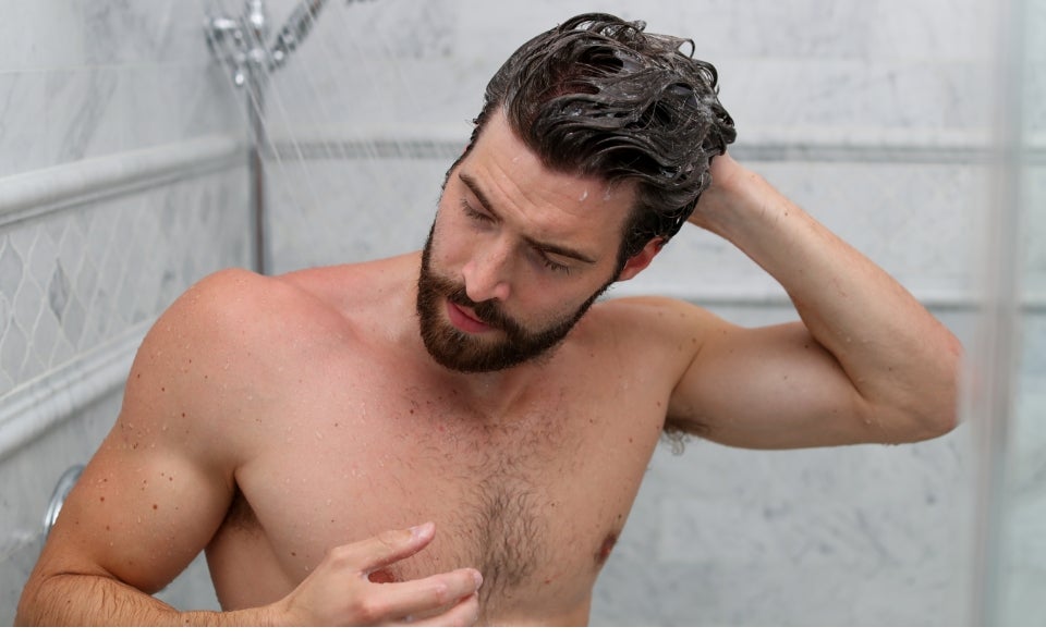 A man washing his hair with the ProLuxe Hair Care System.